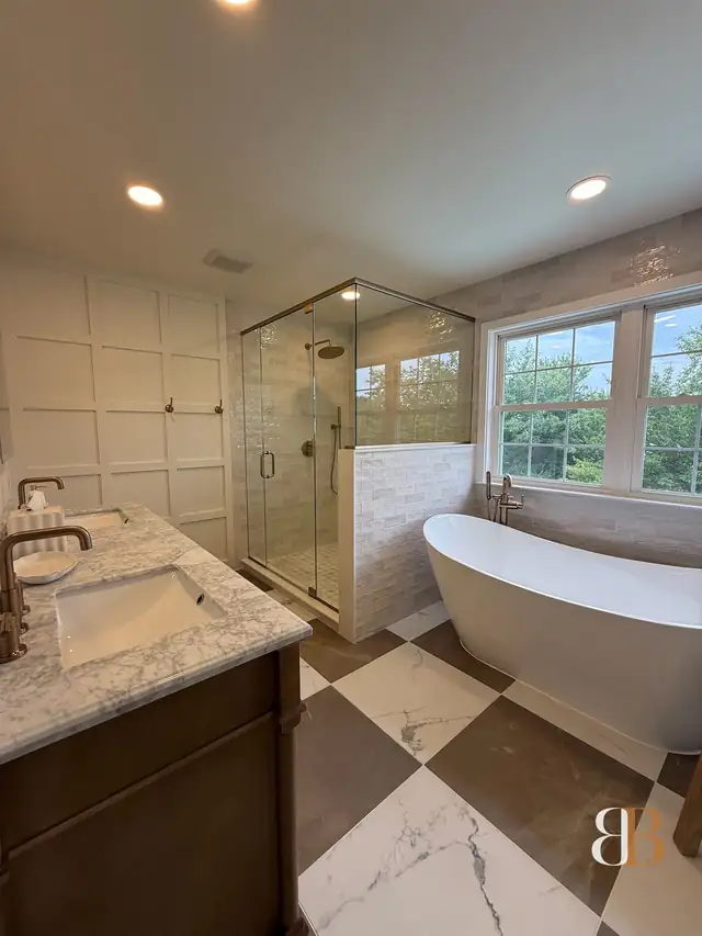 Pipersville master bath with a freestanding tub, a frameless glass shower, white paneled walls, a wood vanity with a marble top and a black and white checkerboard floor